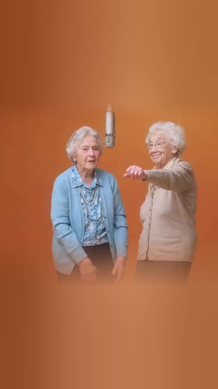 Two grandmas trading verses under the hanging mic.